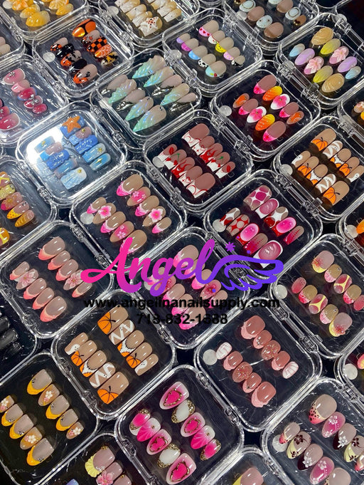 Display of various nail art designs in small plastic cases with 'Angelina Manicure' branding.